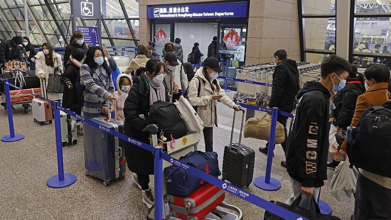 Passengers line up for international departure at Shanghai Pudong International Airport in Shanghai, China, January 8, 2023. /CFP