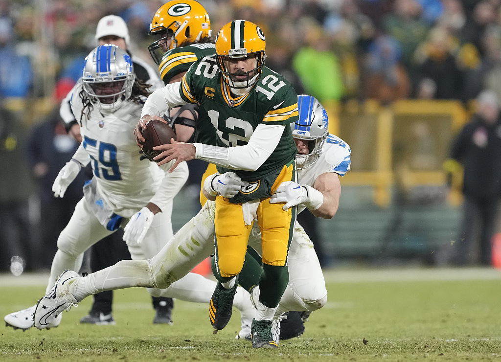 Quarterback Aaron Rodgers (#12) of the Green Bay Packers is sacked by defensive end Aidan Hutchinson of the Detroit Lions in the game at Lambeau Field in Green Bay, Wisconsin, January 8, 2023. /CFP