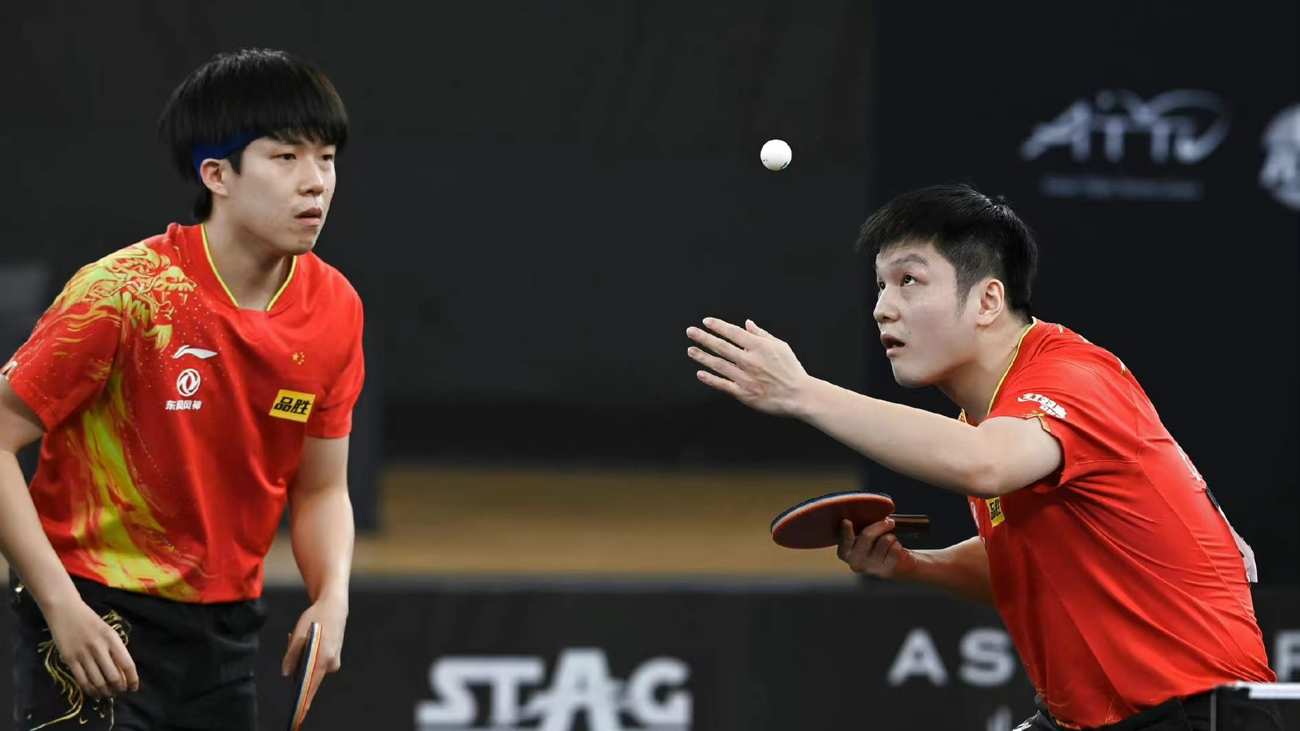 Wang Chuqin (L) and Fan Zhendong in action during the WTTC Asia Continental Stage in Doha, Qatar, January 9, 2023. /Xinhua