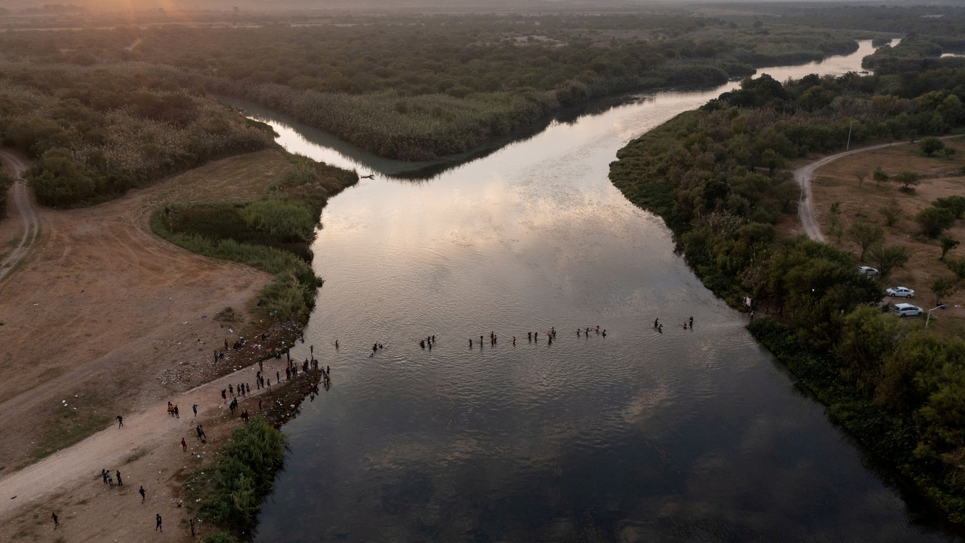 Migrants seeking refuge in the United States cross the Rio Grande River back into Ciudad Acuna, Mexico, from their camp in Del Rio, Texas, the U.S., September 21, 2021. /Reuters