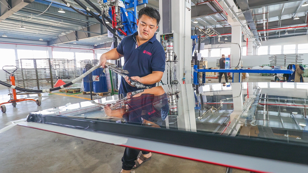 A worker makes glass doors for overseas sale at a factory in east China's Zhejiang Province, November 10, 2022. /CFP