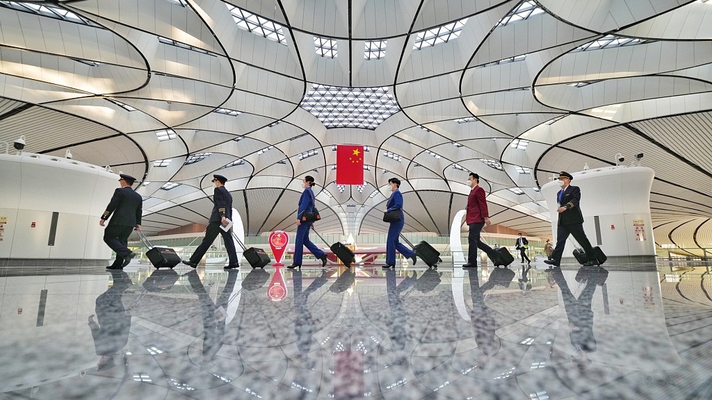 Aircrews walk in the Beijing Daxing International Airport during a test on resuming international passenger flights at the airport, January 10, 2023. /CFP