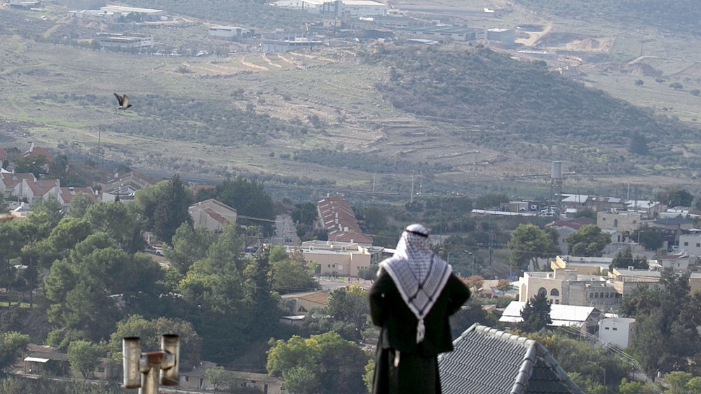A Palestinian man looks towards the Israeli settlement of Shavei Shomron built next to the Palestinian village of Naqoura, west of Nablus in the occupied West Bank, November 23, 2020. /CFP