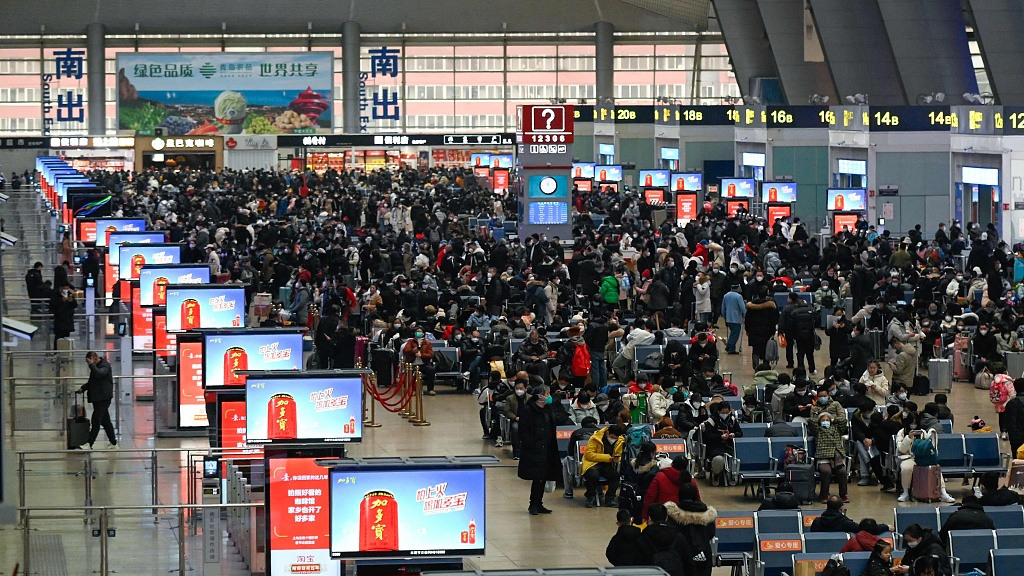 Passengers wait to check in at a railway station in Beijing, China, January 12, 2023. /CFP