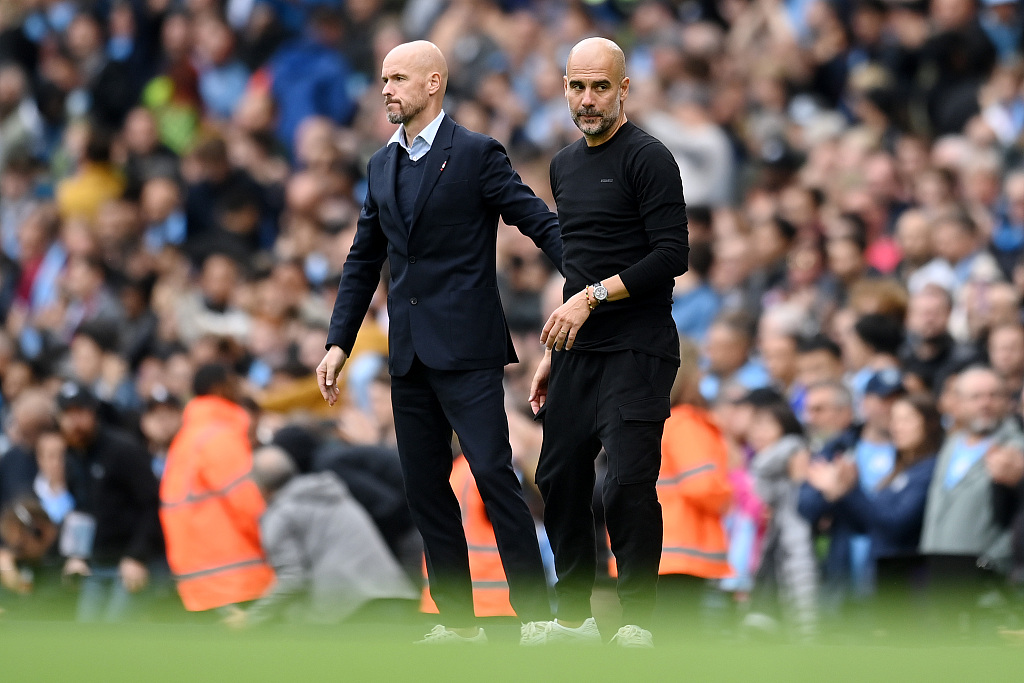 Erik ten Hag (L), manager of Manchester United, and Pep Guardiola, manager of Manchester City, look on during the Premier League game at the Etihad Stadium in Manchester, England, October 2, 2022. /CFP