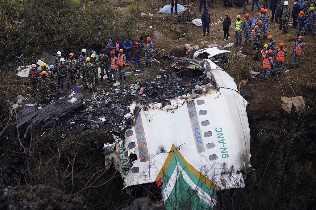 Rescuers scour the crash site of a passenger plane in Pokhara, Nepal, January 16, 2023. /CFP