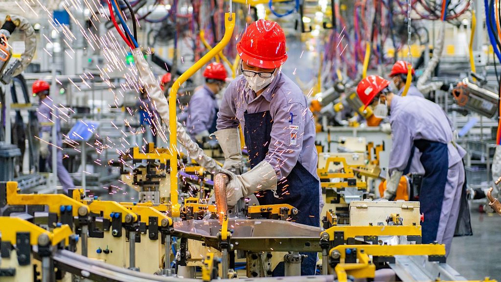 Workers operate at an electric car plant in southwest China's Chongqing municipality, July 19, 2022. /CFP