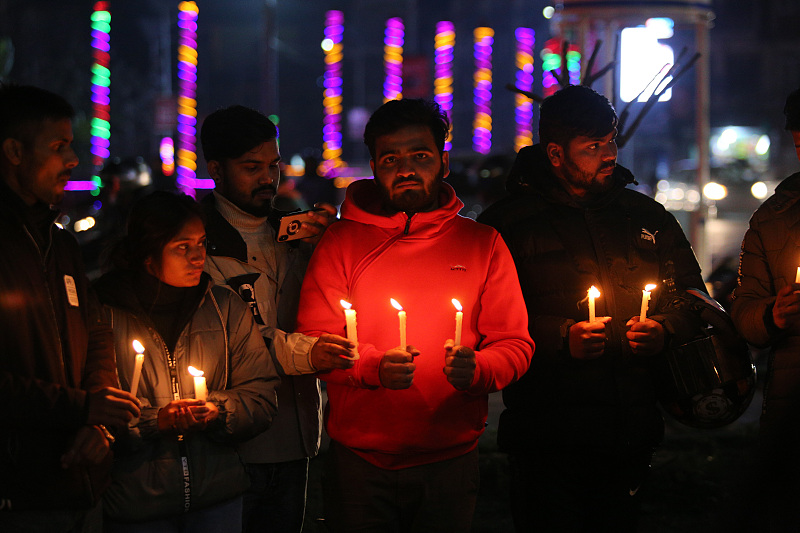 People hold candles during a vigil in memory of victims of a plane crash of a Yeti Airlines operated aircraft in Pokhara, in Kathmandu, Nepal, January 16, 2023. /CFP