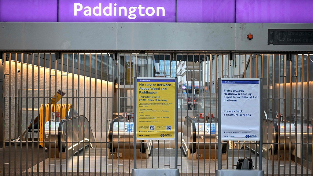 Notice boards are placed in front of barriers blocking the entrance to Elizabeth Line at Paddington station in London amid a new strike by rail workers, January 12, 2023. /CFP