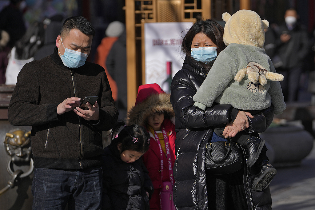 A family visit Qianmen pedestrian shopping street, Beijing, January 17, 2023. /CFP