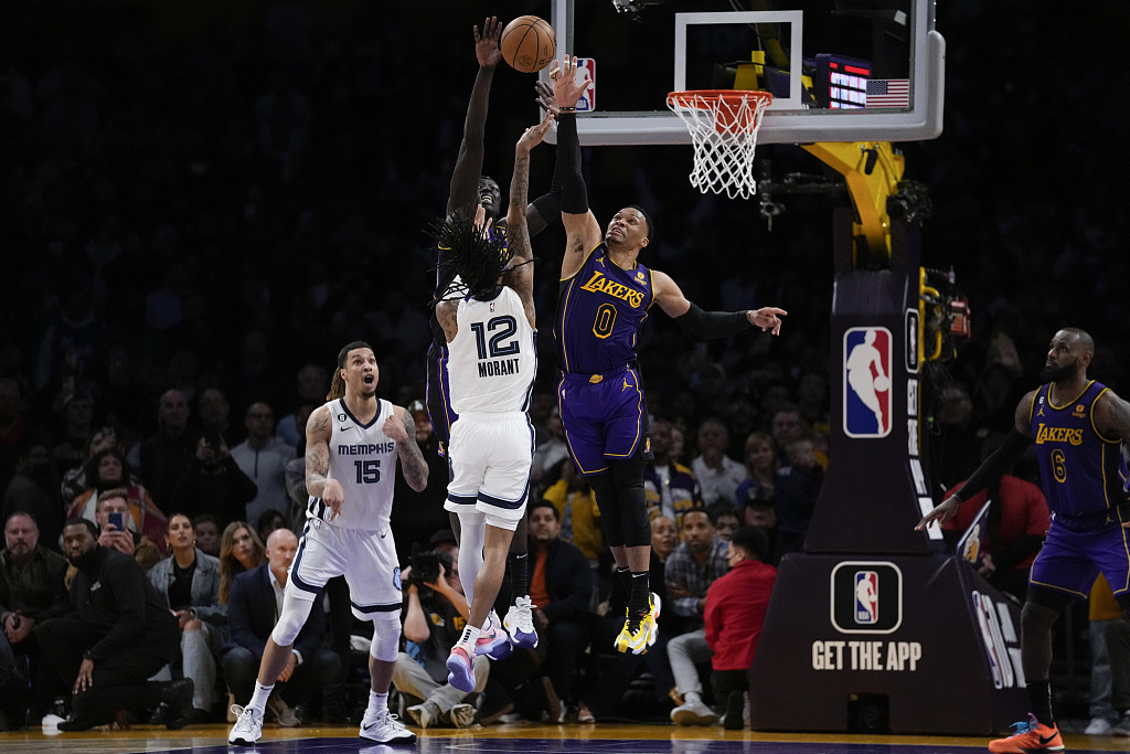 Russell Westbrook (#0) of the Los Angeles Lakers tries to deflect a shot by Ja Morant (#12) of the Memphis Grizzlies in the game at Crypto.com Arena in Los Angeles, California, January 20, 2023. /CFP