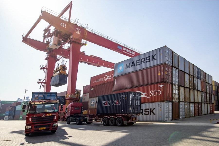 Trucks transport containers at the international container terminal of Taizhou Port in Taizhou, east China's Jiangsu Province, January 17, 2023. /Xinhua