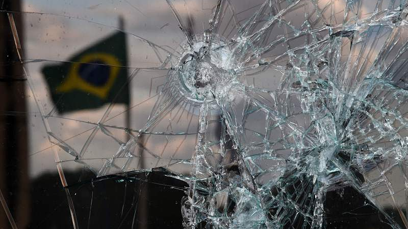 A Brazilian flag is reflected on a broken window of the Supreme Court building in Brasilia, Brazil, January 10, 2023. /CFP