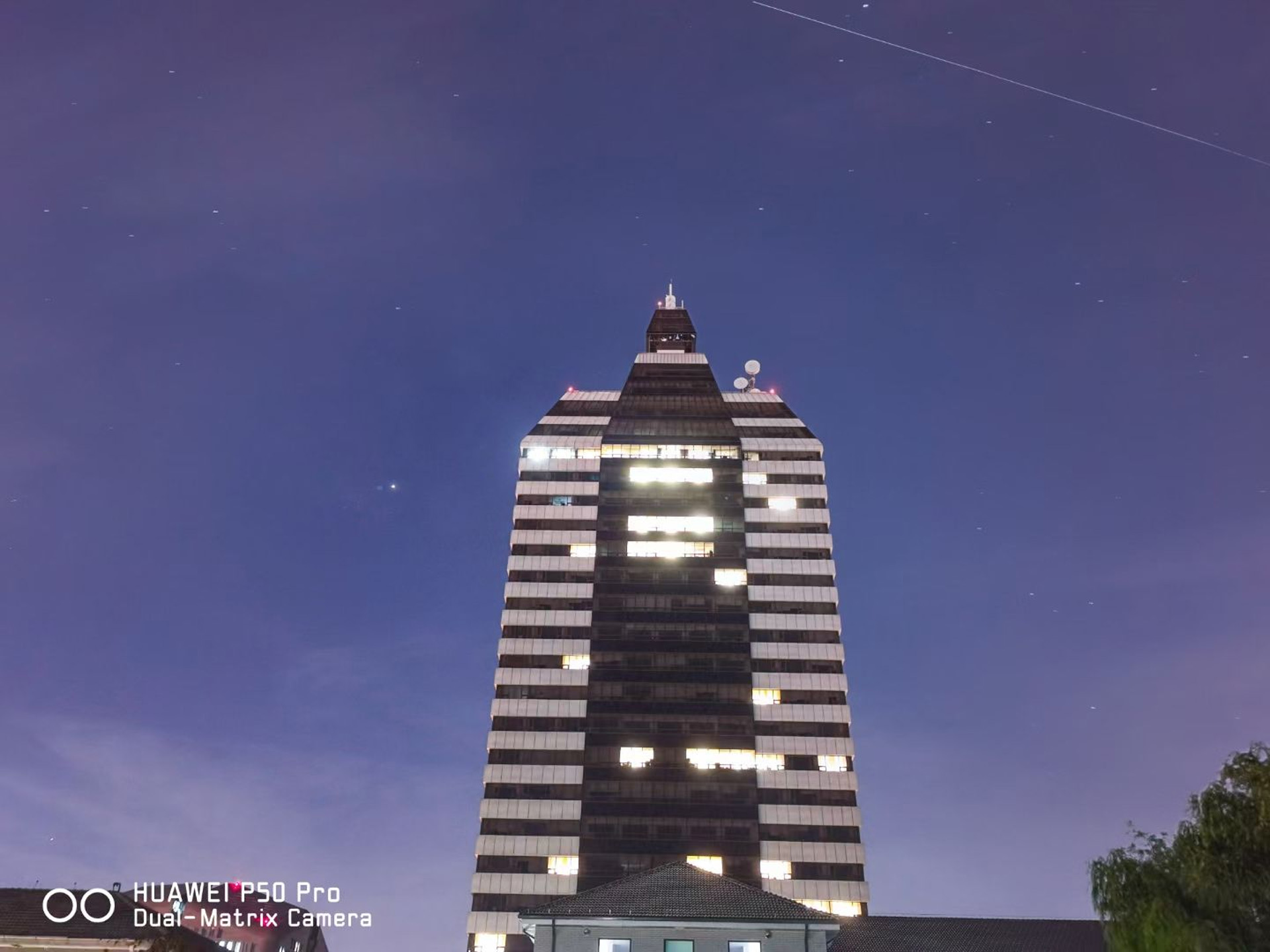 China's space station flies across the sky above the building of Xinhua News Agency in Beijing, China, October 19, 2021. /Wang Junfeng