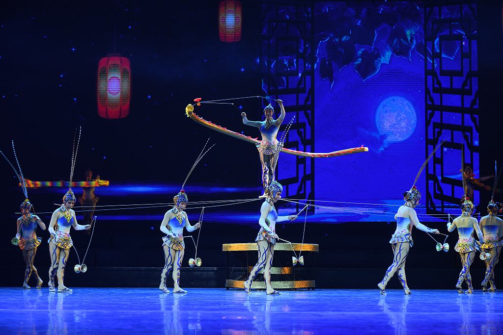Acrobats perform stunts while playing the diabolo, a circus prop, during their performance at the Wuqiao International Acrobatic Festival. /CFP