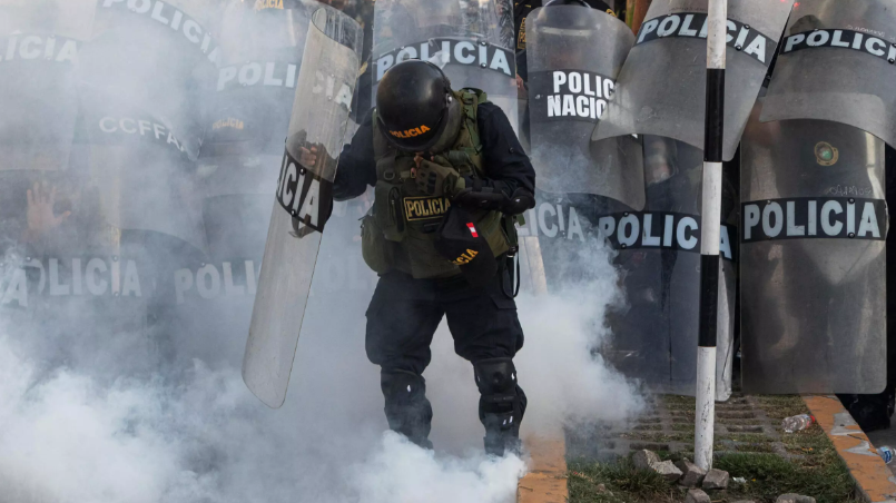 A police officer reacts to tear gas during a demonstration in Lima, Peru, January 26, 2023. /AFP