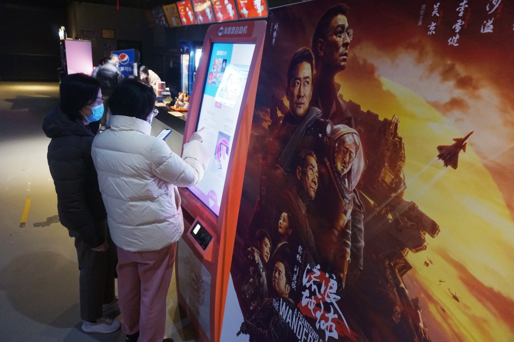 Moviegoers print their tickets using a self-service machine at a local cinema in Hangzhou, east China's Zhejiang, on Jan. 27, 2023. /CFP