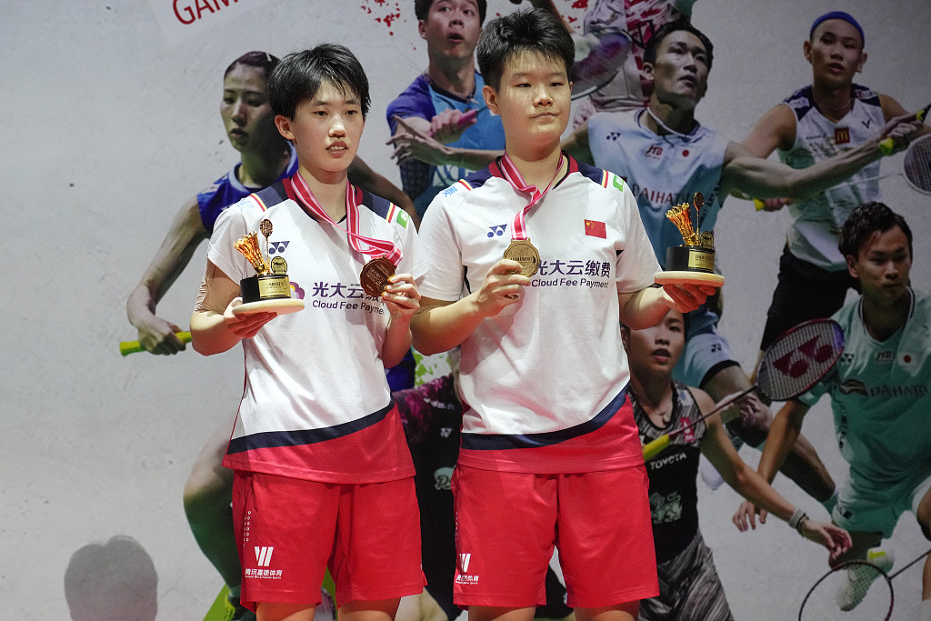 China's Zhang Shuxian (L) and Liu Shengshu celebrate on the podium with their gold medals after winning the women's doubles title at the Indonesia Masters badminton tournament in Jakarta, Indonesia, January 29, 2023. /CFP