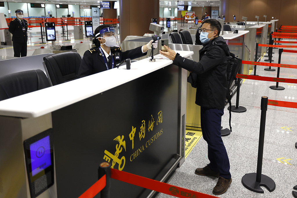 A passenger passes through customs at Beijing Daxing International Airport on January 17, 2023. /CFP