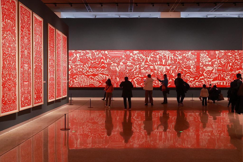 Visitors admire paper-cut works at the China National Arts and Crafts Museum and China Intangible Cultural Heritage Museum in Beijing. /CFP
