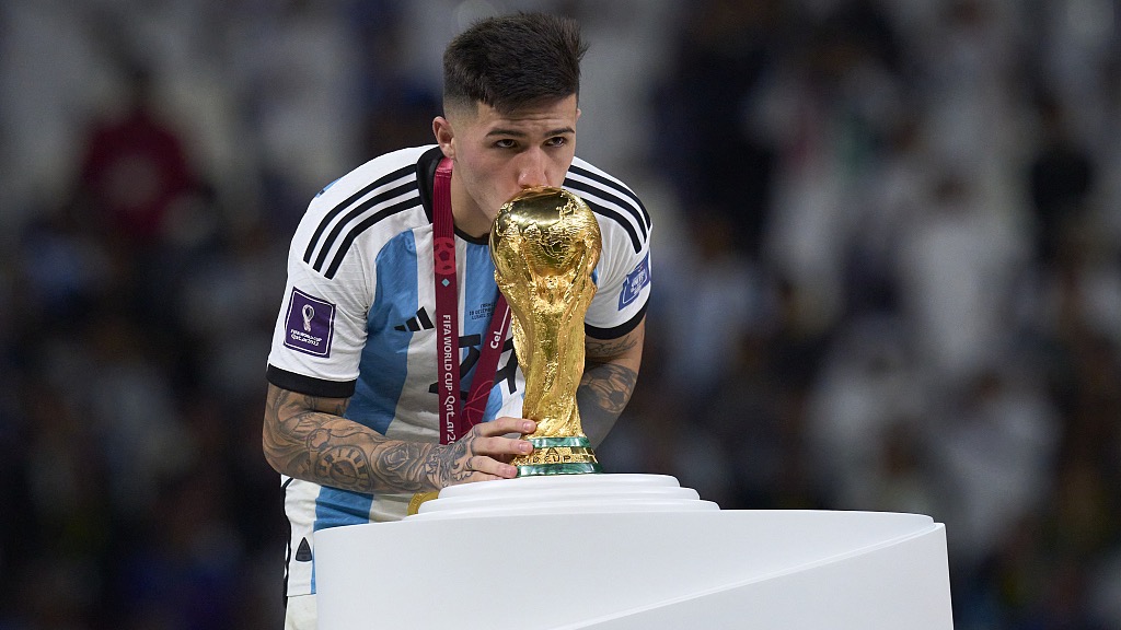 Enzo Fernandez of Argentina kisses the World Cup trophy at the award ceremony following their final win over France at Lusail Stadium in Lusail City, Qatar, December 18, 2022. /CFP