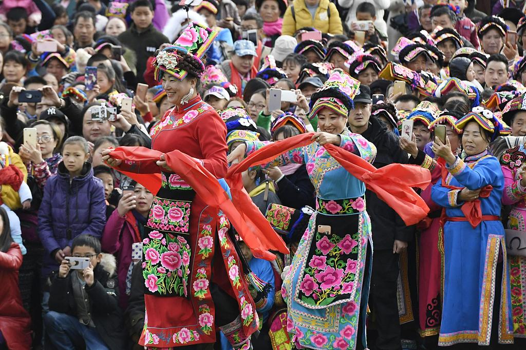 Qiang women in traditional costumes dance during a celebration. /CFP