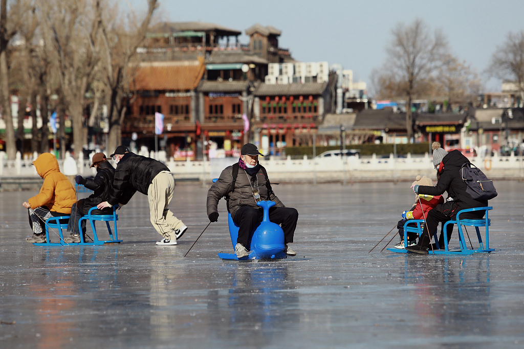 People enjoy winter on the ice at Shichahai, a scenic area in Beijing, December 27, 2022. /CFP