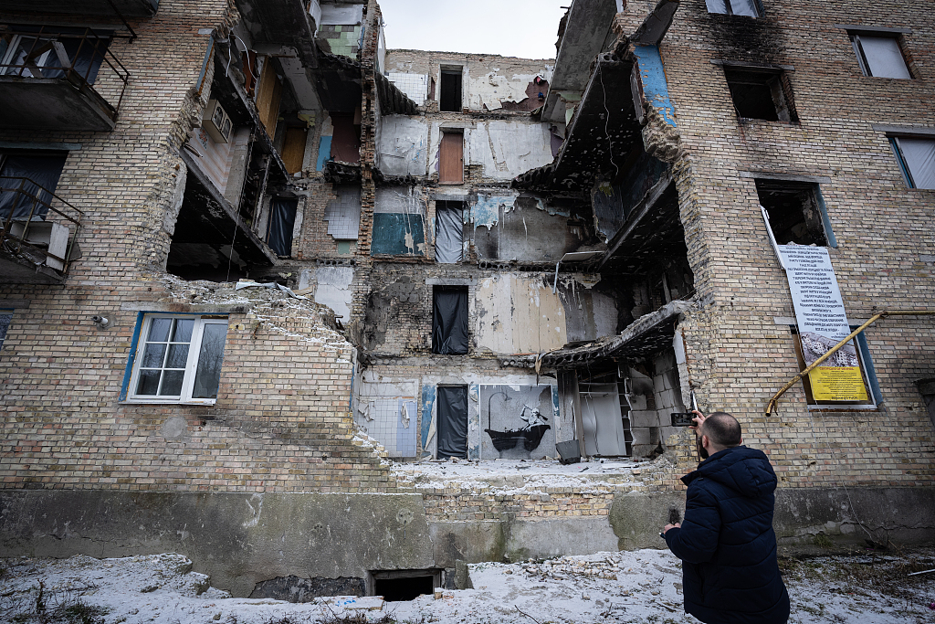 A person watches a destroyed building in Horenka, Ukraine, January 29, 2023. /CFP