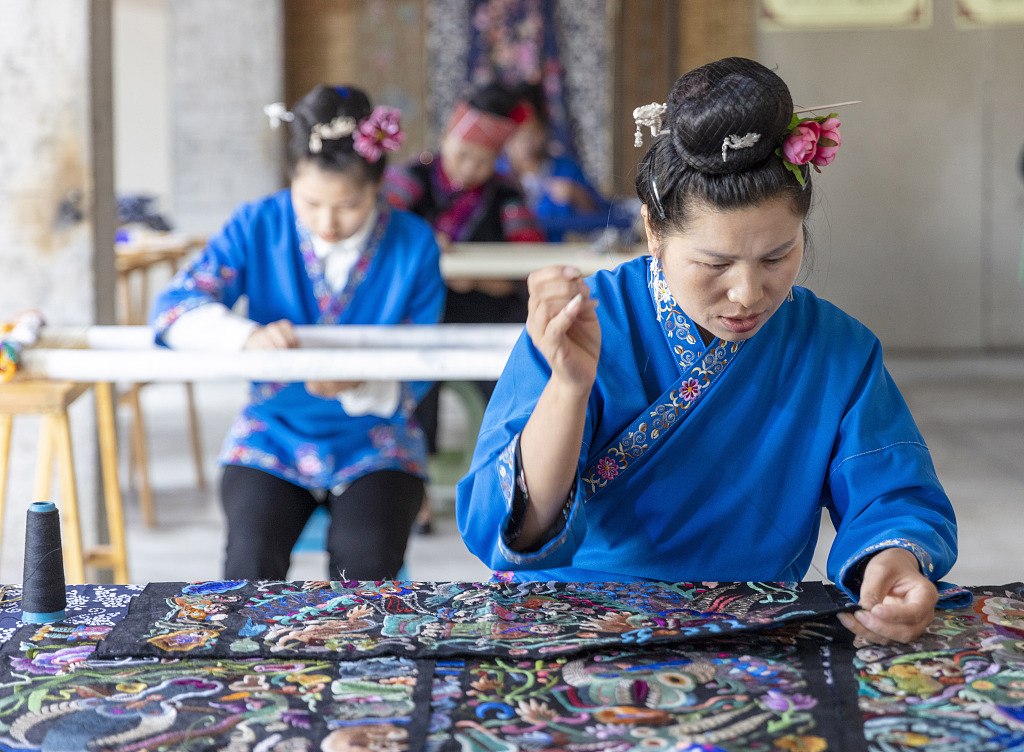 Several Miao women embroider cloth at a factory in Qiandongnan Miao and Dong Autonomous Prefecture, Guizhou Province. /CFP