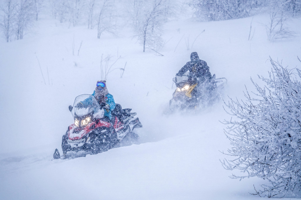 Winter sports enthusiasts experience snowmobiles at Changbai Mountain Nature Reserve. /CFP
