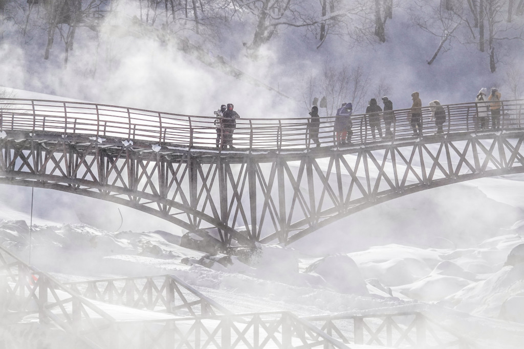 Tourists admire the scenery from a bridge in Changbai Mountain Nature Reserve. /CFP