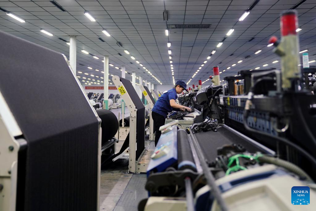 A worker works in a textile company in Xingtai, north China's Hebei Province, February 6, 2023. /Xinhua