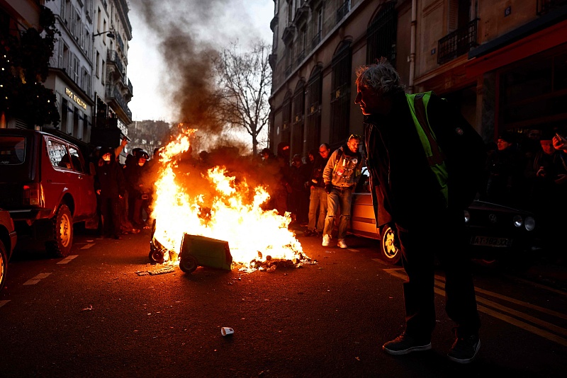 Protesters stand by burning trash as clashes erupt during a demonstration against a deeply unpopular pensions overhaul in Paris, France, February 7, 2023.
