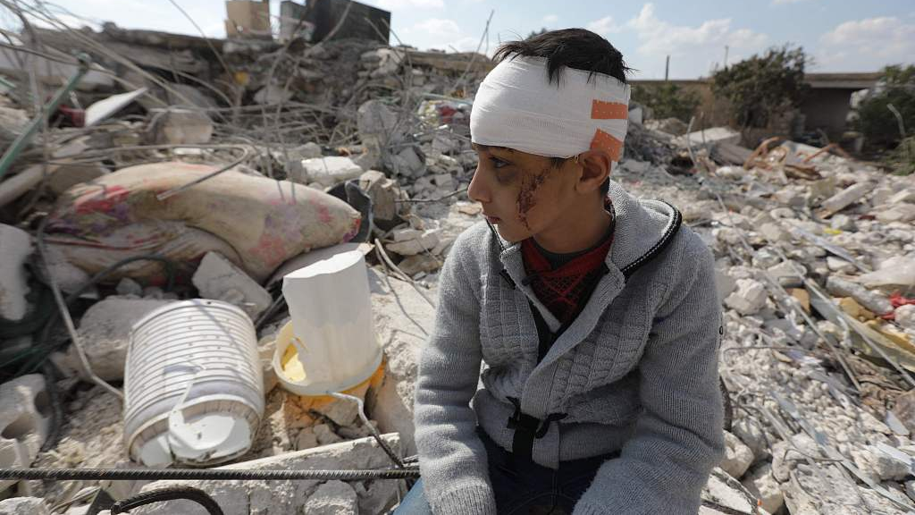 A boy sits amid the rubble of his home in the town of Jindayris, Aleppo Province, Syria, February 11, 2023. /CFP