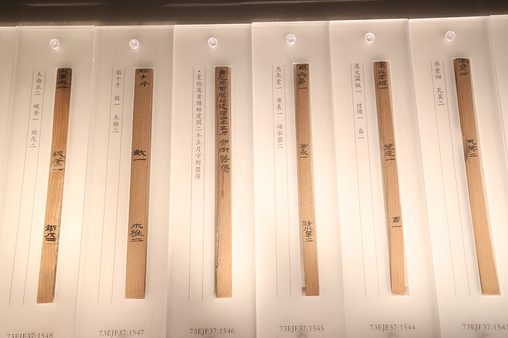 Copies of bamboo slips unearthed from the Juyan Fortress are displayed at an exhibition of ancient documents and historical materials discovered during the early 20th century at the National Library of China in Beijing on February 15, 2023. /CFP