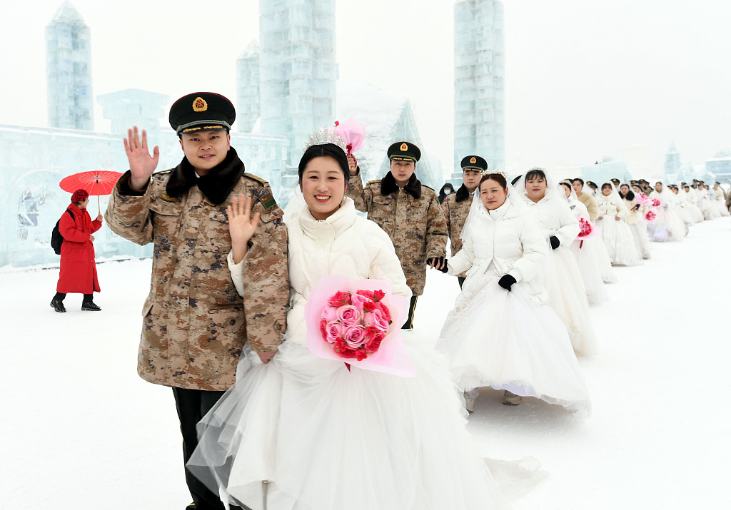 With snow sculptures as a romantic backdrop, a group wedding is held at the Harbin Sun Island Snow Sculpture Art Expo for the military personnel on February 11, 2023. /CFP