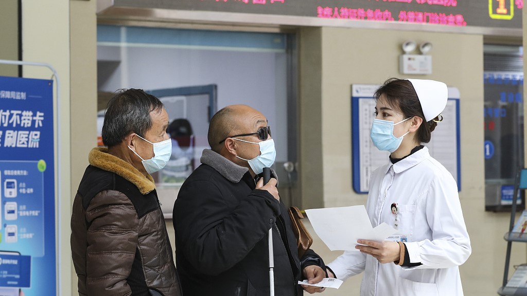 A nurse explains the new health insurance reform to patients in Huai'an, east China's Jiangsu Province, February 12, 2023. /CFP