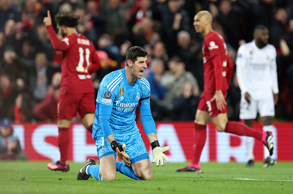 Thibaut Courtois (C), Real Madrid's goalkeeper, reacts after allowing a goal in the first-leg game of the UEFA Champions League Round of 16 competitions against Liverpool at Anfield in Liverpool, England, February 21, 2023. /CFP