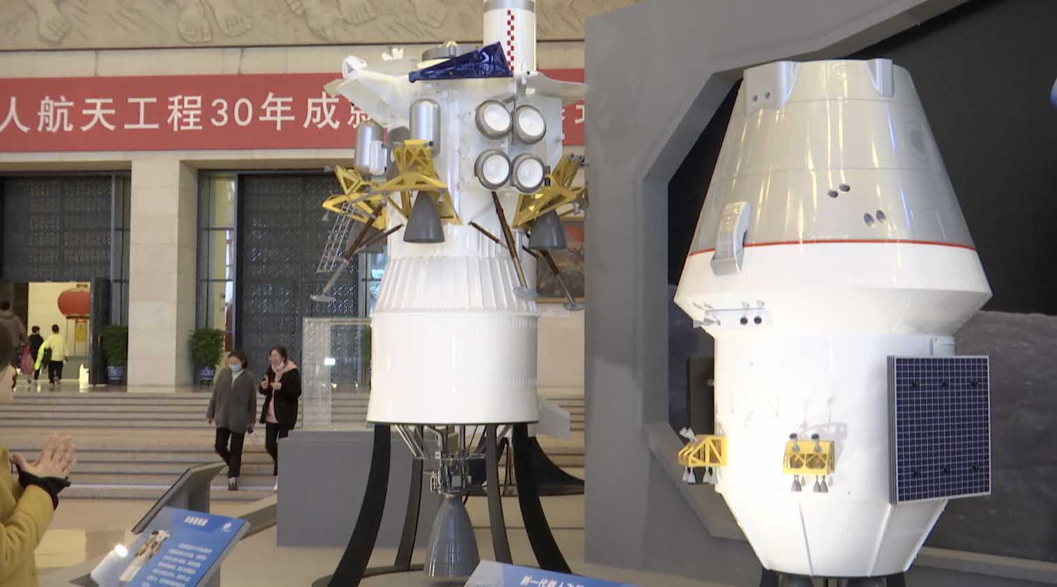 Models of a moon lander (L) and China's next-generation manned spacecraft (R) make their debuts at an exhibition in Beijing, China, February 24, 2023. /CGTN