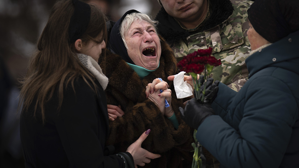 A woman cries outside a church at the funeral of her son, a Ukrainian serviceman who was killed due to the conflict, in Kyiv, Ukraine, February 11, 2023. /CFP