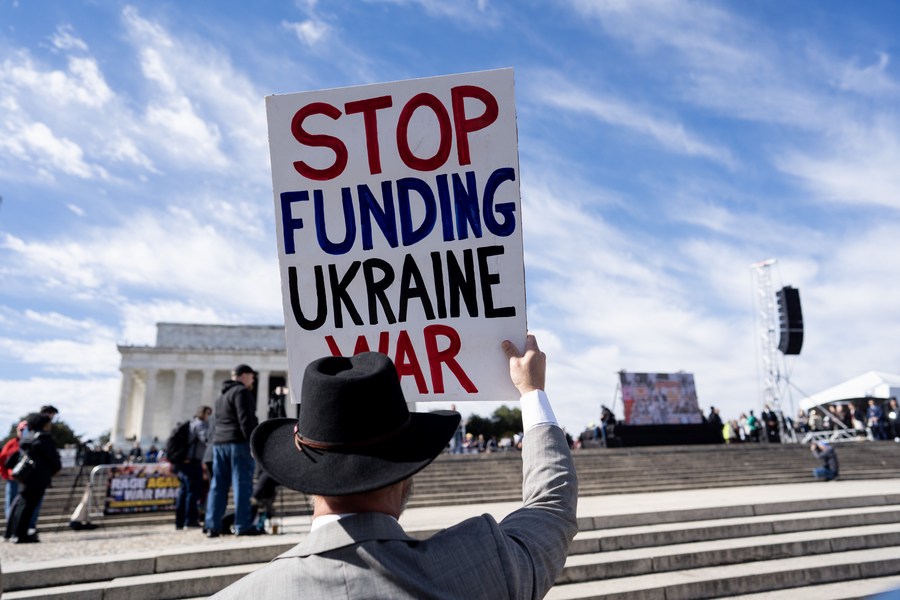 A demonstrator holds a slogan during the anti-war rally in Washington, D.C., the United States, February 19, 2023. /Xinhua