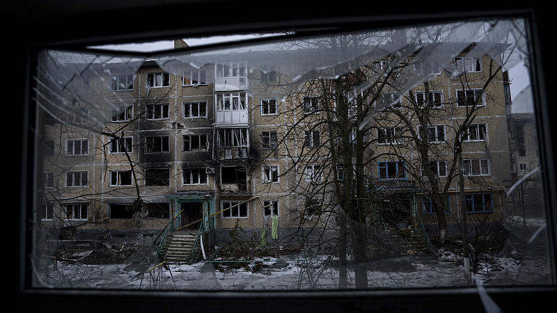 A destroyed residential building is seen through the broken window, in the frontline city of Vuhledar, Ukraine, February 25, 2023. /CFP