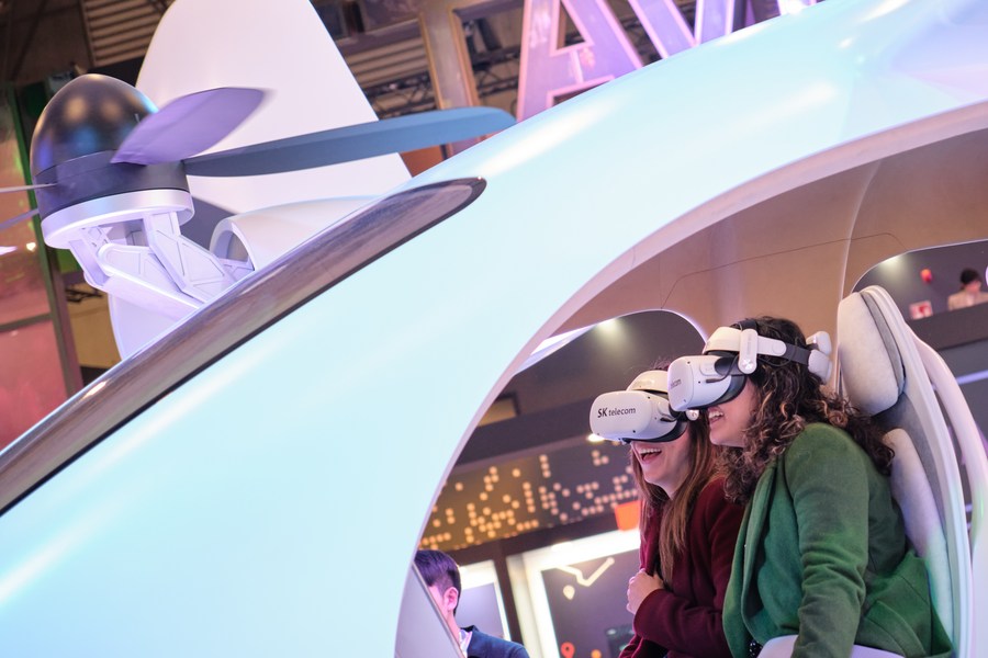 Visitors try on VR headsets at the 2023 MWC, February 27, 2023. /Xinhua
