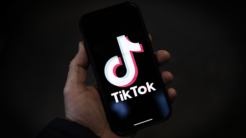  A TikTok logo is displayed on an iPhone. /CFP