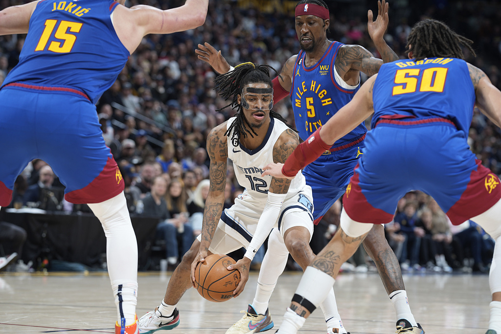 Ja Morant (#12) of the Memphis Grizzles holds the ball in the game against the Denver Nuggets at Ball Arena in Denver, Colorado, March 3, 2023. /CFP