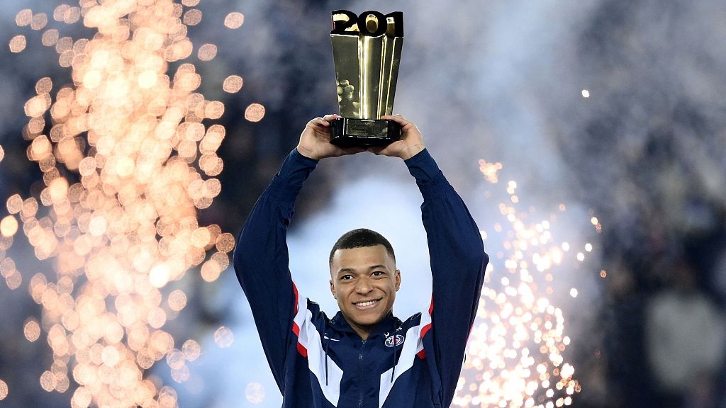 Paris Saint-Germain's Kylian Mbappe raises a trophy during a ceremony after he became the club's all-time top scorer at The Parc des Princes Stadium in Paris, France, March 4, 2023. /CFP