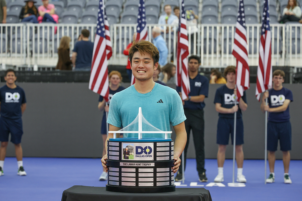 China's Wu Yibing poses with the Lamar Hunt Trophy after winning the Dallas Open in Texas, U.S., February 12, 2023. /CFP
