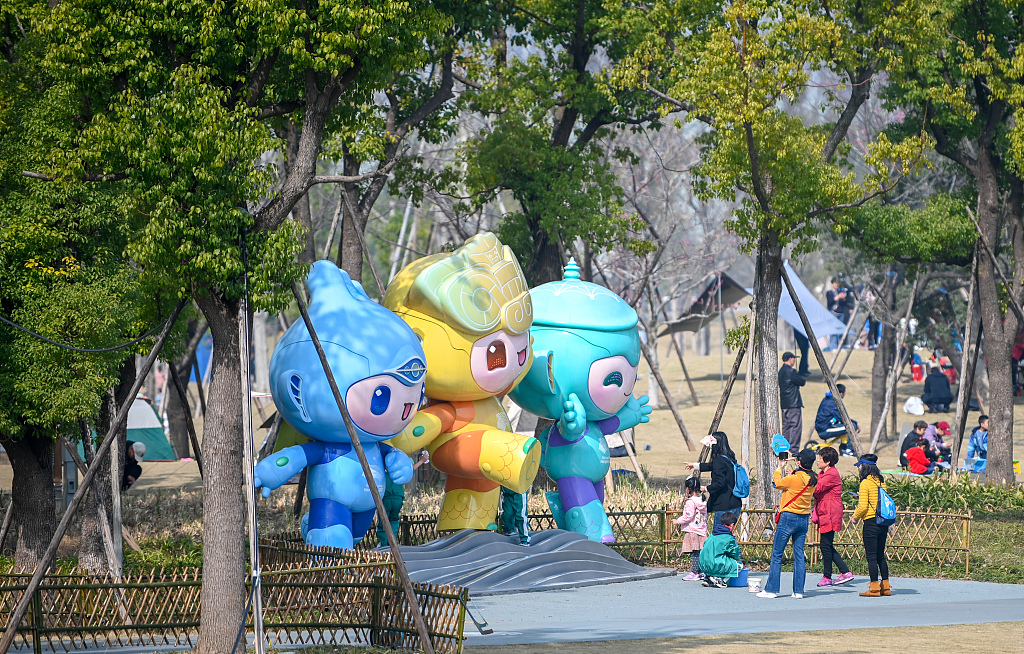 Visitors take photos of the Asian Games mascots at a park in Hangzhou, Zhejiang Province, March 5, 2023. /CFP