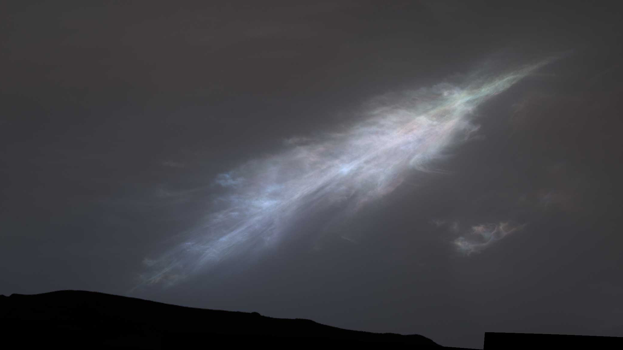 This feather-shaped iridescent cloud was captured just after sunset on January 27, 2023, the 3,724th Martian day of Curiosity's mission. /NASA