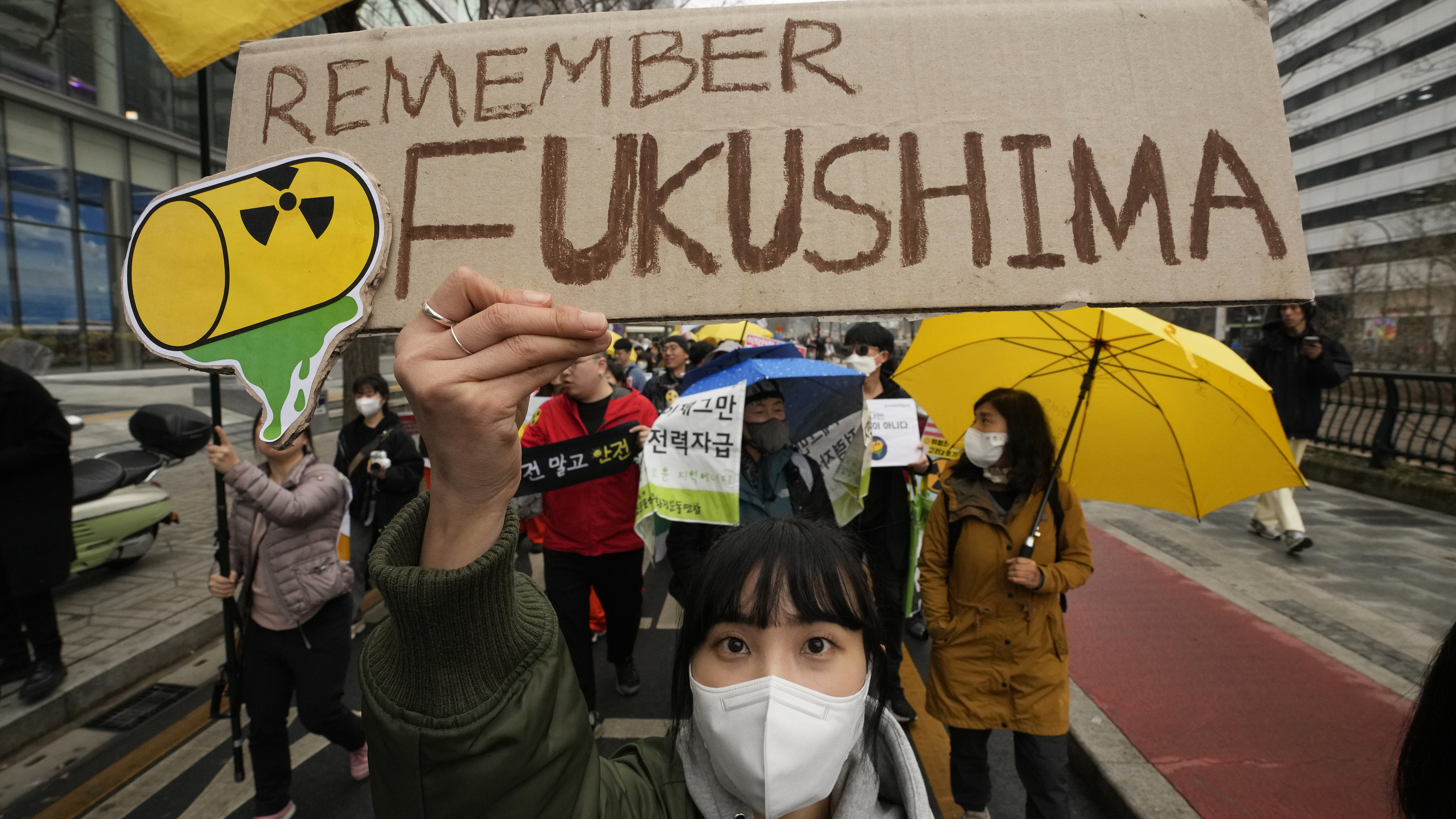 Environmental activists march during a rally marking the 12th anniversary of Fukushima nuclear disaster, in Seoul, South Korea, March 9, 2023. They denounce Japan's planned release of treated radioactive wastewater into the sea. /CFP